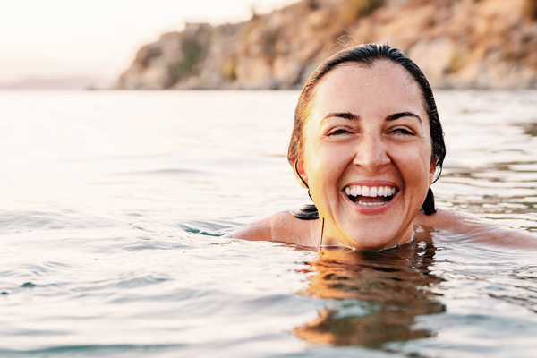 happy woman swimming out side